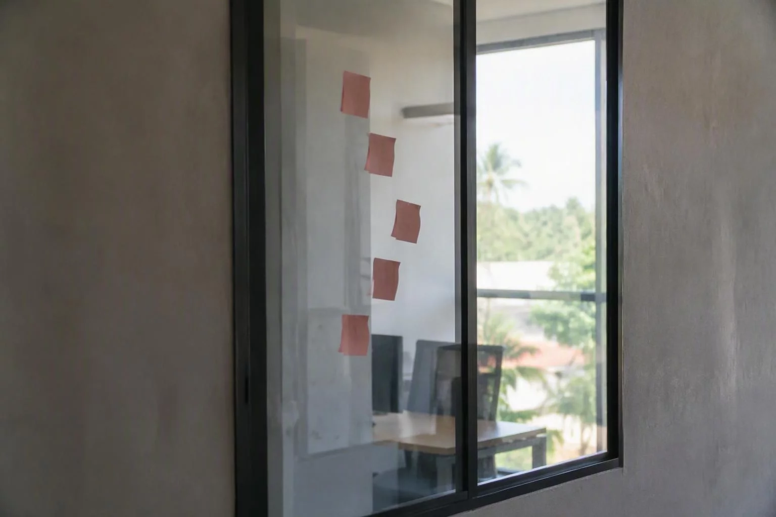 Vidro do escritório com adesivos das versões já publicadas